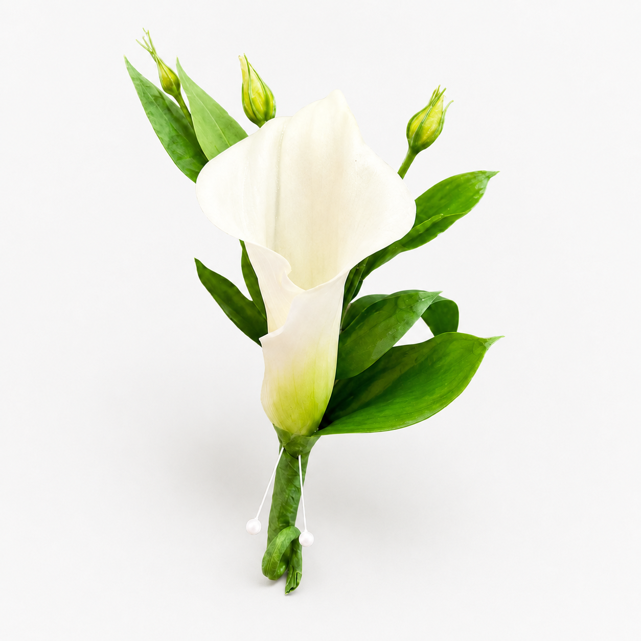 Classic white calla lily boutonnière with greenery and pearl accents by Heather Floral NYC