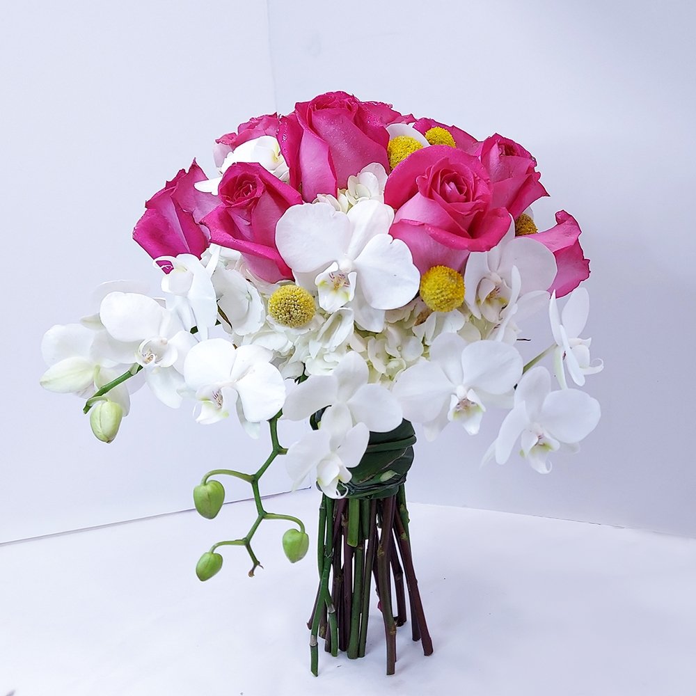 Brightly colored mixed flower bouquet by Heather Floral, featuring white Phalaenopsis orchids and pink roses