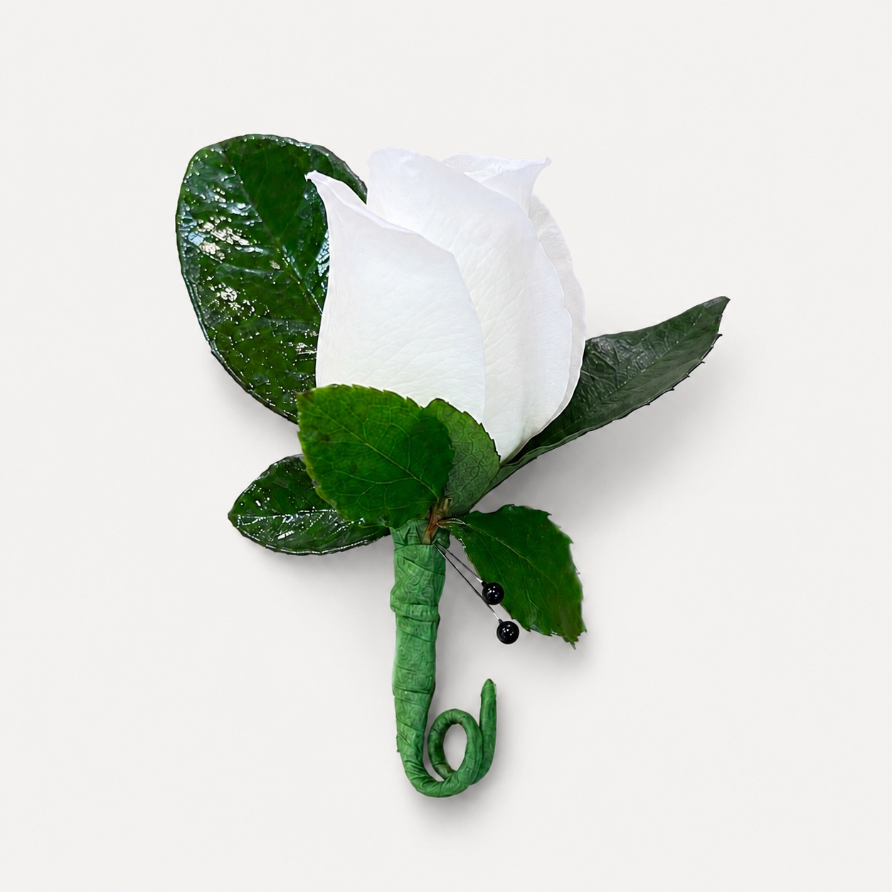 Classic white rose boutonnière with fresh greenery and decorative black pearl accents by Heather Floral NYC.